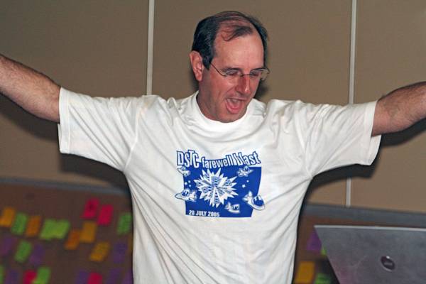 Mark Gibson, revealing the DSTC Farewell T-Shirt,  | DSTC Farewell Symposium, 28 July 2005  | 